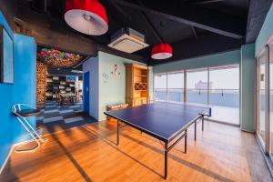 a ping pong room with a ping pong table at THALAY Cha-am by THA in Cha Am
