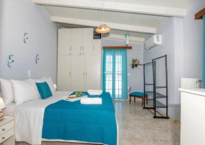 a bedroom with a bed with a blue blanket at DM-Discover Margarites Home in Margarítai