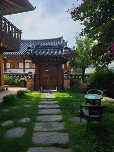 a walkway leading to a building with a bench at Hanji Gguljam in Jeonju