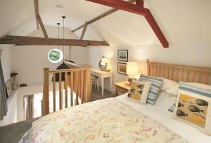 a bedroom with a bed and a desk at The Maltings in Trunch