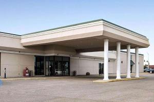 a large building with pillars in a parking lot at Baymont by Wyndham Jamestown Conference Center & Water Park in Jamestown