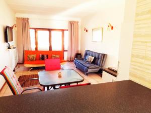 a living room with a couch and a table at Saint Michael's Sandcastles in Margate