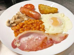 a plate of food with eggs bacon beans and meat at The B & B Blackpool in Blackpool