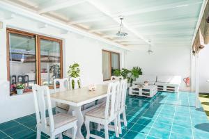 a dining room with blue flooring and a table and chairs at Villa Neon Tenerife in Arona