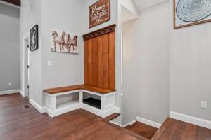 a hallway with a wooden door with a bench at Adorable Reymer Carriage Repair Loft! in Pittsburgh