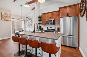a kitchen with a large kitchen island with bar stools at Adorable Reymer Carriage Repair Loft! in Pittsburgh