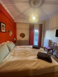 a bedroom with a large bed with a chandelier at Comfortable apartment in Thessaloniki in Thessaloniki