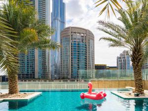 a swimming pool with a red float in a city at Sofitel Dubai Downtown in Dubai