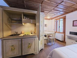 a kitchen with a sink and a desk in a room at Grand Hotel Ceresole Reala Biloapartment in Ceresole Reale