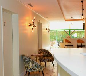 a kitchen and dining room with chairs and a table at Best Western Gemenos en Provence in Gémenos