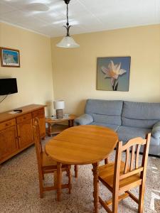 a living room with a table and a couch at Apartamentos Congo in El Campello