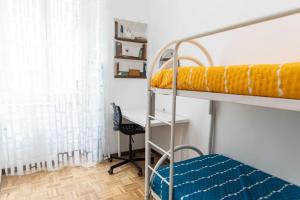 a bunk bed with a desk and a chair in a room at Nova Domus Colosseo in Rome