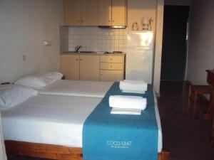 A bed or beds in a room at Galini Studios and Apartments