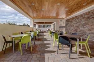 a restaurant with tables and chairs and a brick wall at Home2 Suites By Hilton Las Vegas Southwest I-215 Curve in Las Vegas