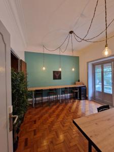 an empty room with a long table and chairs at Castilho 63 Hostel & Suites in Lisbon