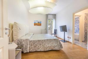Schlafzimmer mit einem Bett und einem Flachbild-TV in der Unterkunft Quadrilocale Corso Italia 29 piano terra con spazio esterno in Gallipoli