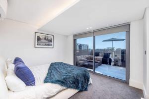 a white couch in a room with a large window at 102 Aurum Residences by Totalstay in Cape Town