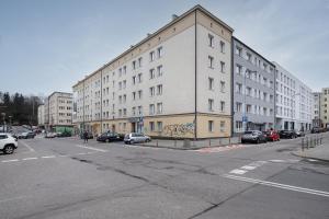 a large white building on a city street with parked cars at 27 Gdynia Centrum - Apartament Mieszkanie dla 2 os in Gdynia