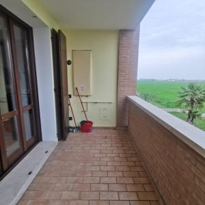 a balcony with a door and a view of a field at Casa Reggio Emilia in Reggio Emilia