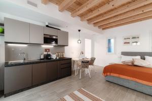 cocina y dormitorio con cama y mesa en Numero 11 Piazza Amendola - by MyHomeInComo, en Como