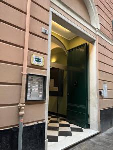 an entrance to a building with a green door at Genova Gold Rooms in Genova