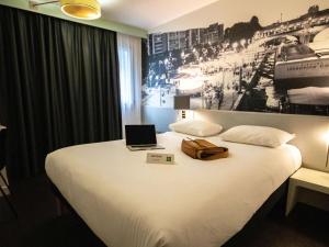 une chambre d'hôtel avec un lit et un ordinateur portable. dans l'établissement ibis Styles Paris Tolbiac Bibliotheque, à Paris