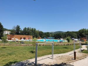 a swimming pool with people in a park at Casa Ponte Pedrinha in Tarouca