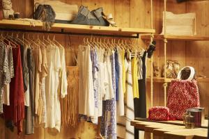 a closet filled with lots of clothes on racks at Hippie Chic Hotel in Agios Ioannis Mykonos