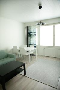 sala de estar con mesa blanca y sillas en Cozy downtown studio in Turku en Turku