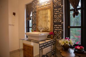 a bathroom with a sink and a mirror at Isla's Ridge - A CGH Earth SAHA Experience in Kodaikānāl +58 photos