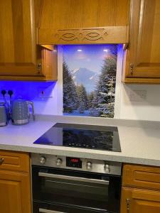 a kitchen with a window with a view of a mountain at Cosy Highland Cottage Tyndrum centrally located in Tyndrum