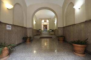 an empty hallway with potted plants in a building at Loft Germanico in Rome
