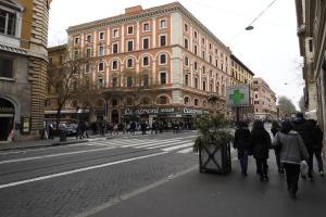 a group of people walking down a city street at Loft Germanico in Rome