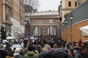 a crowd of people walking down a busy city street at Loft Germanico in Rome