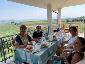 a group of women sitting at a table with food at TENUTA FATTORE in Santa Maria Imbaro