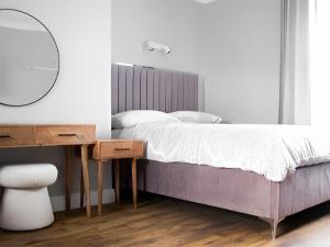 a bedroom with a bed and a desk with a mirror at Lilydale Retreat in Lanchester