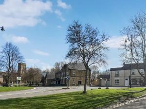 a building with a tree in the middle of a street at Lilydale Retreat in Lanchester