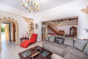 a living room with a couch and a table at Villa Hidden Gem Crete in Pangalochori