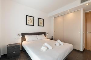 a bedroom with a bed with two white pillows at Apartamento ático primera línea Playa Canyelles in Roses