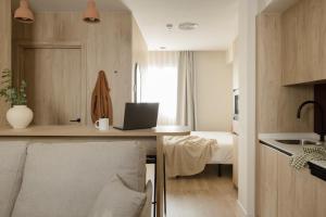 a small kitchen with a desk with a laptop on it at Líbere Bilbao Ledesma in Bilbao