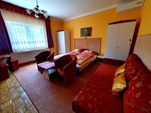 a hotel room with a bed and a couch at Apart Júlia Villa in Hévíz