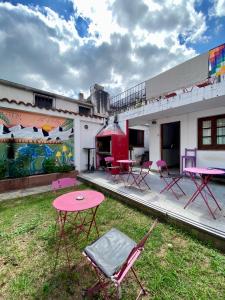 a group of chairs and tables in the yard of a building at Esperanto hostel in Salta