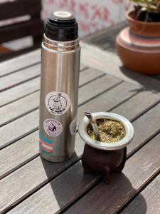 a thermos and a bowl of spices on a table at Esperanto hostel in Salta
