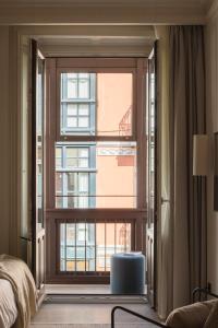 a bedroom with a large window with a view at Líbere Bilbao Ledesma in Bilbao