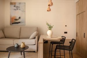 a living room with a couch and a table and chairs at Líbere Bilbao Ledesma in Bilbao