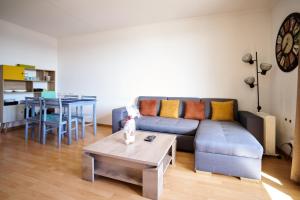 a living room with a couch and a table at Appartement Cosy proche Gare TGV et Centre ville. in Avignon