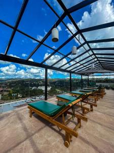 a group of picnic tables on top of a building at Chris Park Hotel in Campos do Jordão