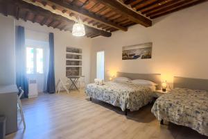 1 dormitorio con 2 camas y suelo de madera en Residenza Portoferraio en Portoferraio