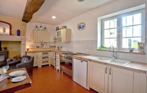 a large kitchen with white cabinets and a sink at Cozy Home In Appeville in Appeville