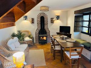 a living room with a table and a fireplace at Casa Arenas in Arenas de Cabrales